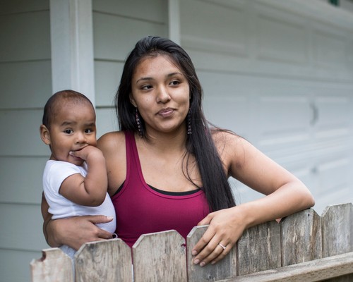 A young mother holding her baby in her arms
